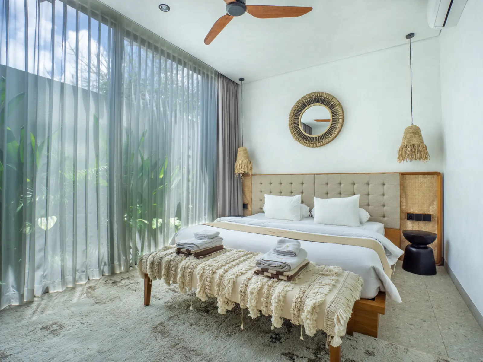 Bedroom with garden view and ceiling fan in an apartment at Rahya Villas, Uluwatu