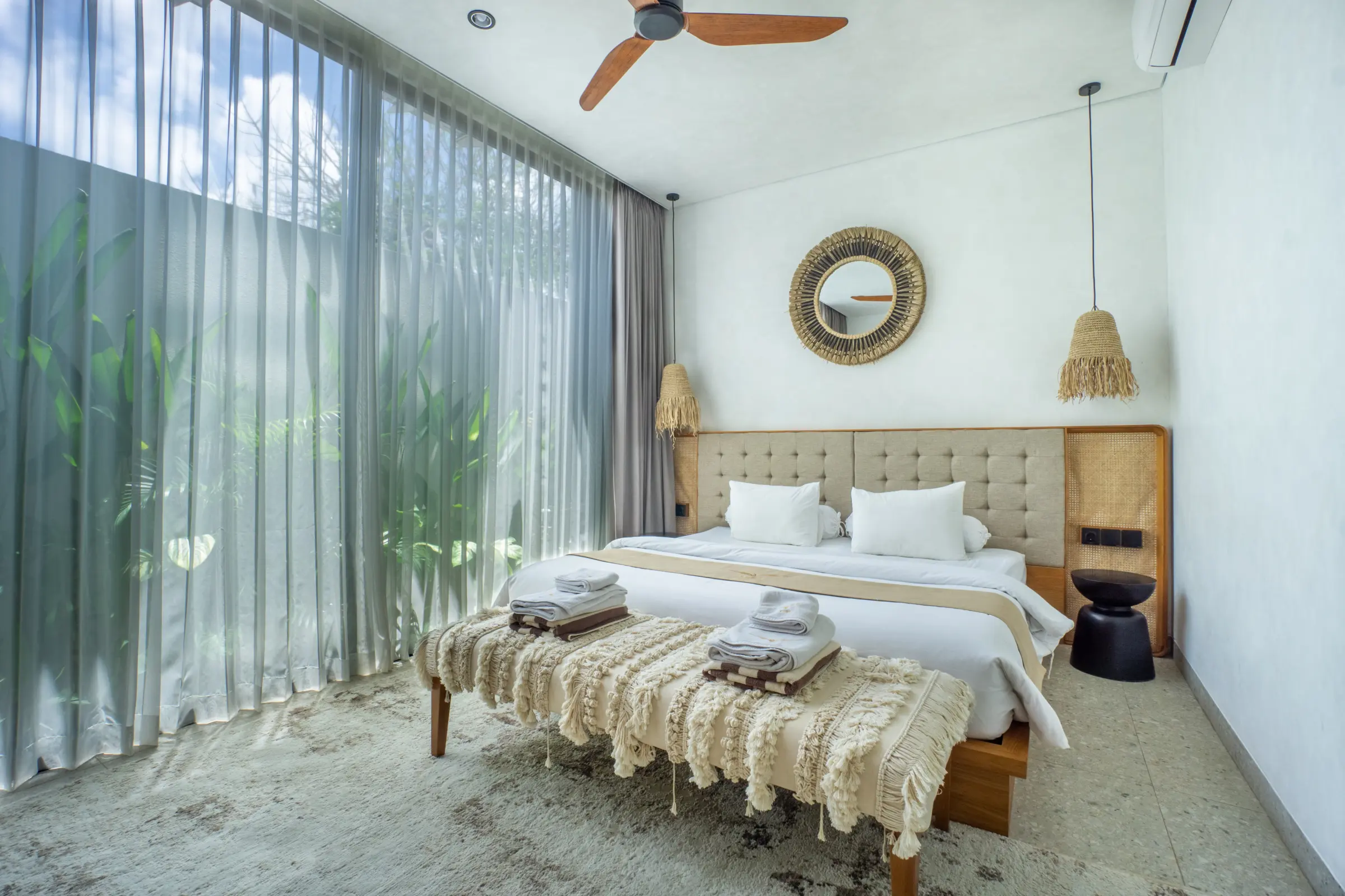 Bedroom with garden view and ceiling fan in an apartment at Rahya Villas, Uluwatu