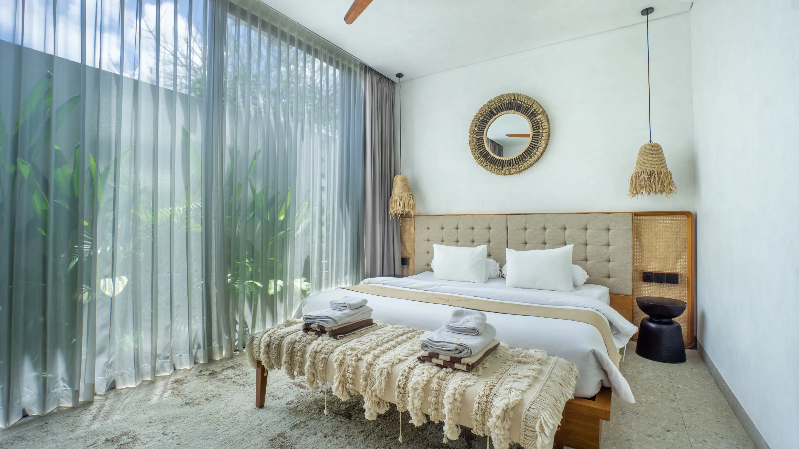 Bedroom with garden view and ceiling fan in an apartment at Rahya Villas, Uluwatu