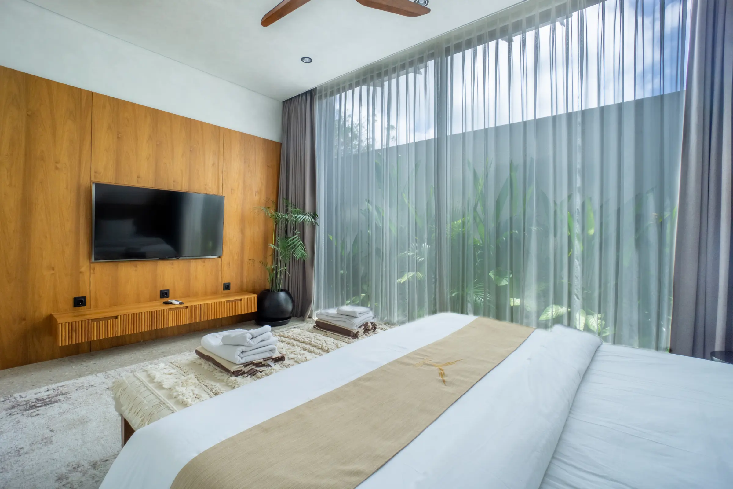 Bedroom with wall-mounted television and floor-to-ceiling curtains, Rahya Villas, Uluwatu