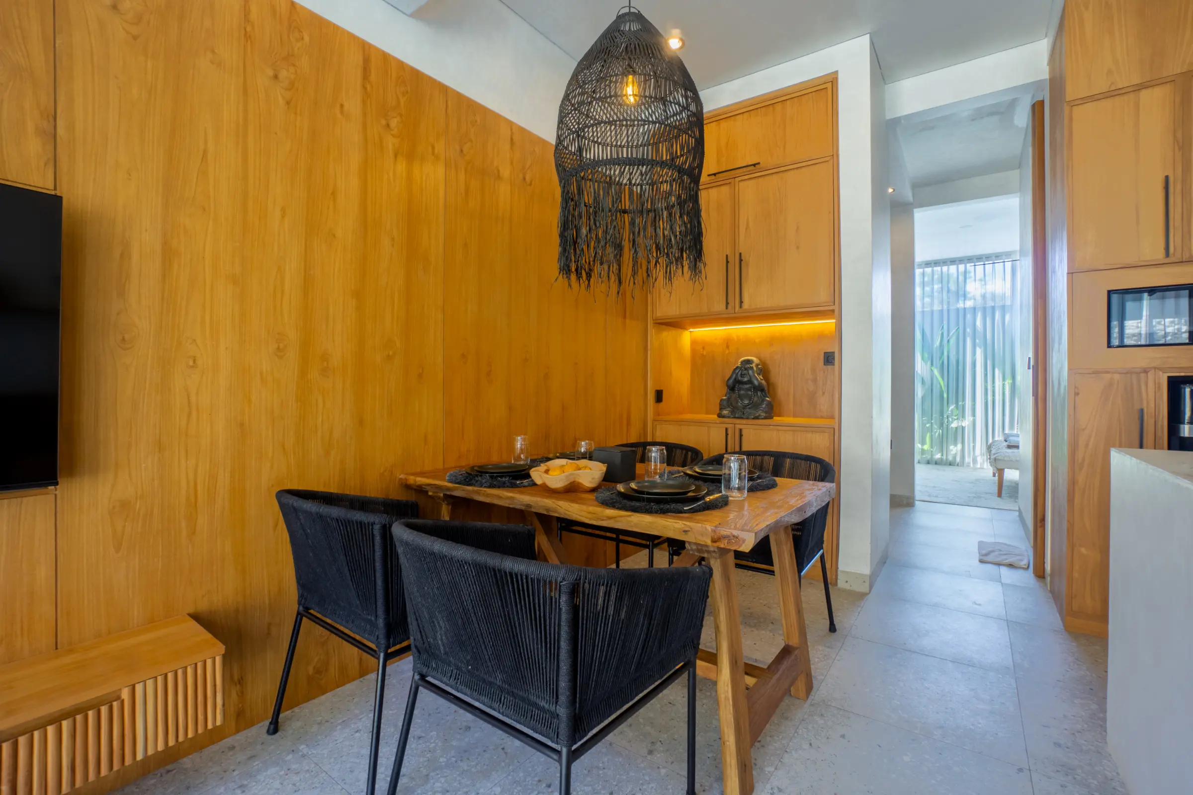 Dining table for two beside a timber wall in an apartment at Rahya Villas, Uluwatu