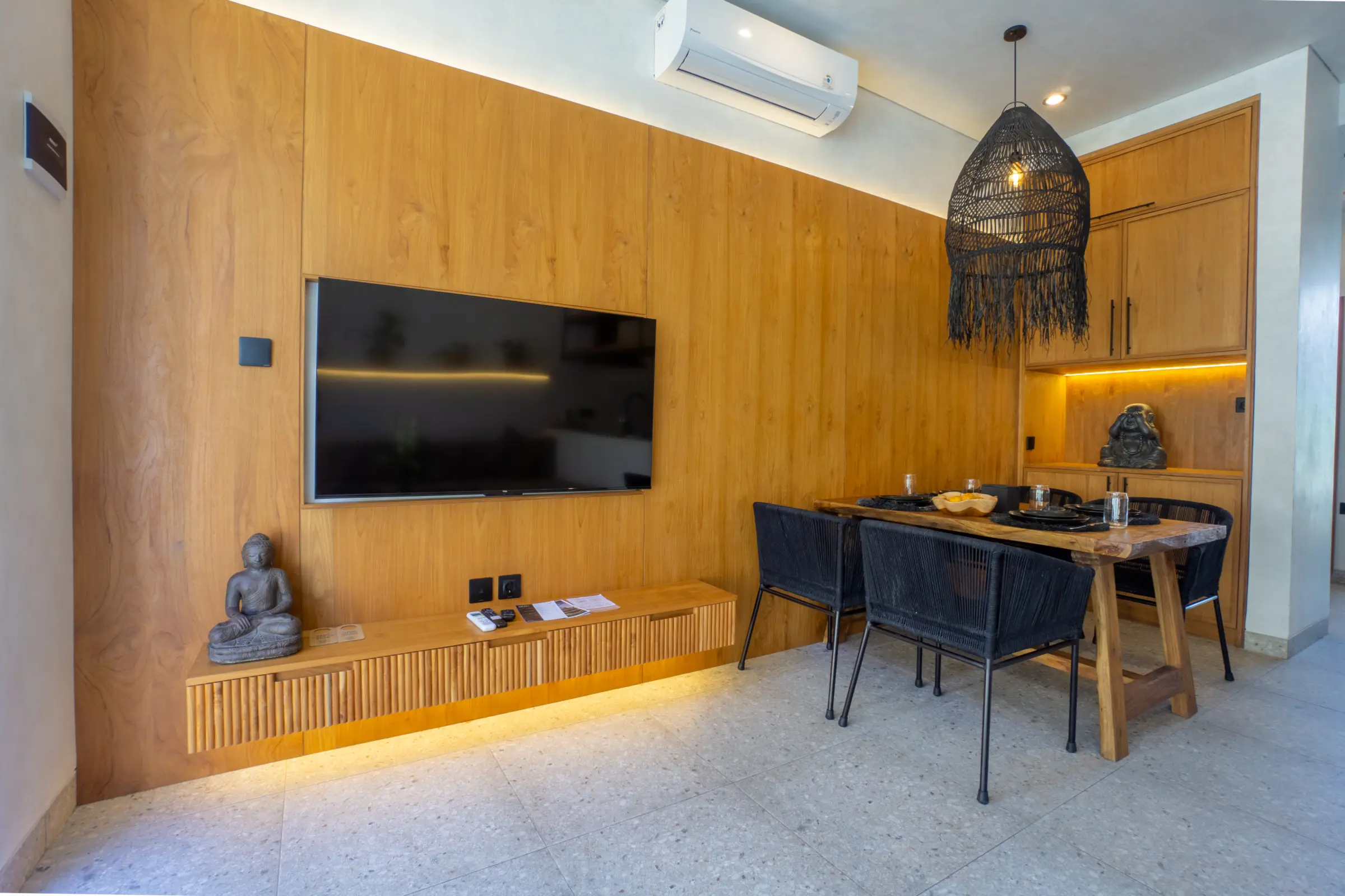 Living area with television and dining table in an apartment at Rahya Villas, Uluwatu
